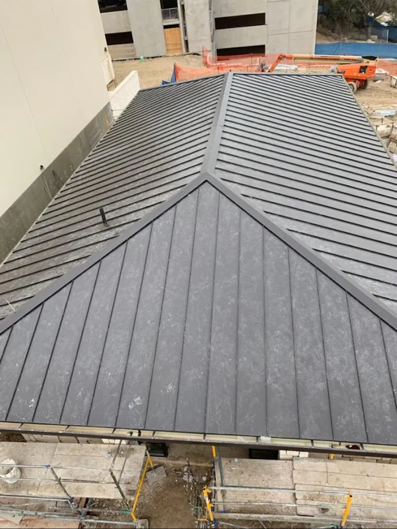 Commercial metal roof construction with crane equipment in Zanesville